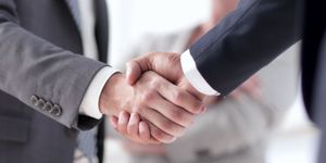 Image showing two businesspeople shaking hands indicating acquisition