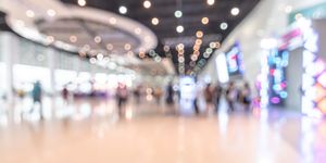 Blurred background of an exhibition hall signifying tech conference.