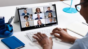 man on video conference at a desk