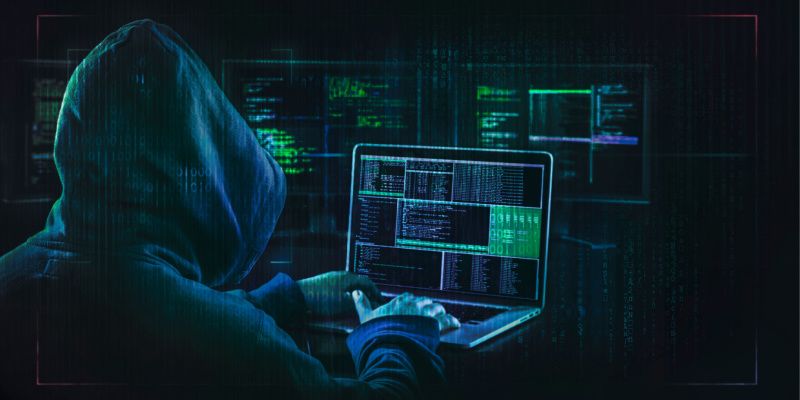 Image depicting a hacker writing a code to exploit vulnerabilities