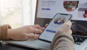 Employee using microsoft teams on phone and computer