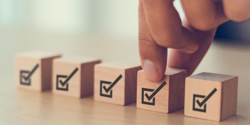 A series of boxes with tick marks on it, illustrating the audit checklists that belong in compliance management systems.